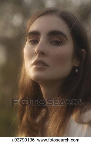 Stock Photograph - Portrait of young woman in sunlight. Fotosearch