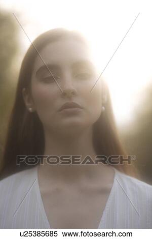Stock Photography - Portrait of young woman in sunlight. Fotosearch