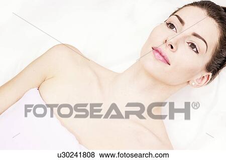 Portrait of young woman lying on couch in clinic. View Large Photo Image Stock Photo - Portrait of young woman lying on couch in clinic.. Fotosearch