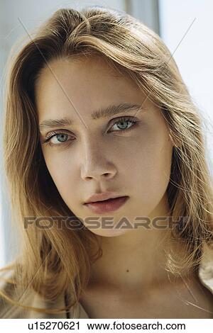 Stock Image - Portrait of young woman wearing natural make-up. Fotosearch
