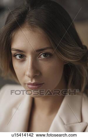 Stock Image - Portrait of young woman wearing natural make-up. Fotosearch