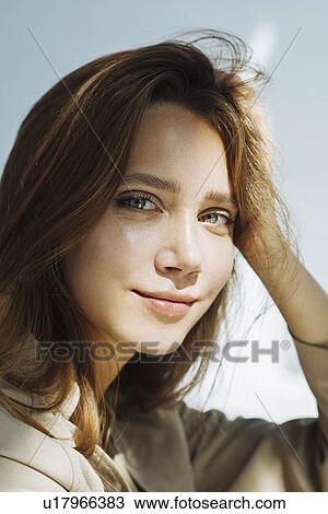 Stock Image - Portrait of young woman wearing natural make-up. Fotosearch
