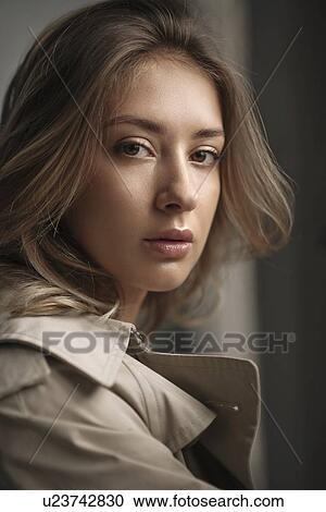 Stock Image - Portrait of young woman wearing natural make-up. Fotosearch
