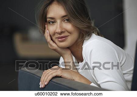 Stock Image - Portrait of young woman wearing natural make-up. Fotosearch