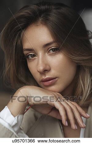 Stock Photograph - Portrait of young woman wearing natural make-up. Fotosearch