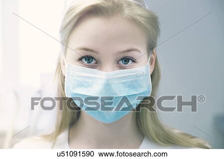 Portrait of young woman wearing surgical mask View Large Photo Image Stock Image - Portrait of young woman wearing surgical mask. Fotosearch