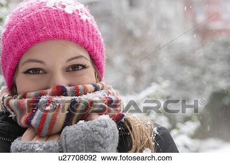 Portrait of young woman wearing woolly hat and scarf in snow View Large Photo Image Stock Image - Portrait of young woman wearing woolly hat and scarf in snow. Fotosearch