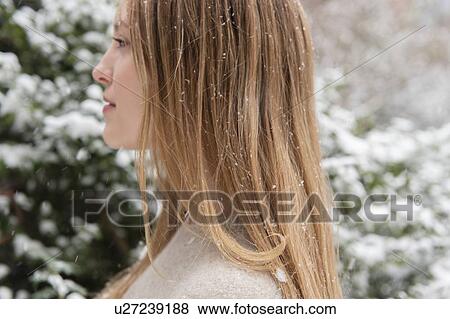 Profile of young woman in snow View Large Photo Image Stock Photo - Profile of young woman in snow. Fotosearch