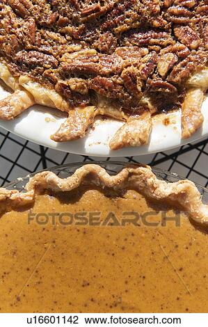Stock Image - Pumpkin and pecan pies on a cooling rack. Fotosearch