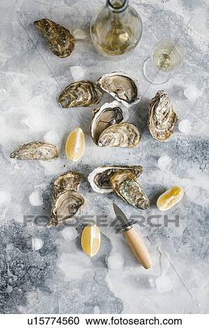 Raw oysters with lemon and champagne View Large Photo Image Stock Image - Raw oysters with lemon and champagne. Fotosearch