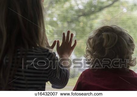 Rear view of children looking out window View Large Photo Image Stock Photo - Rear view of children looking out window. Fotosearch