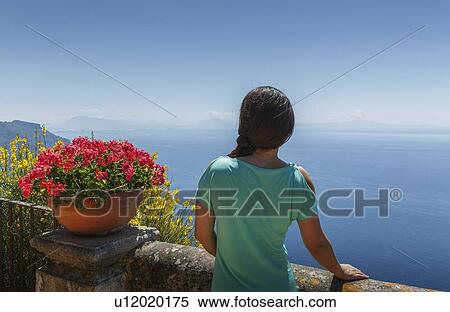 Stock Photography - Rear view of woman by flower pot. Fotosearch