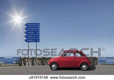 Red car by road sign on Amalfi Coast, Italy View Large Photo Image Stock Photo - Red car by road sign on Amalfi Coast, Italy. Fotosearch