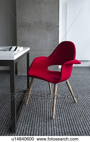 Stock Image - Red chair by desk. Fotosearch