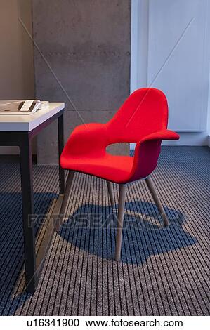 Stock Image - Red chair by desk. Fotosearch