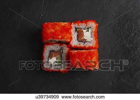 Stock Photo - Red fish roe sushi on black surface. Fotosearch
