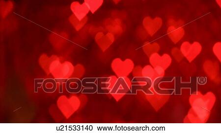 Stock Image - Red heart shaped lens flares. Fotosearch