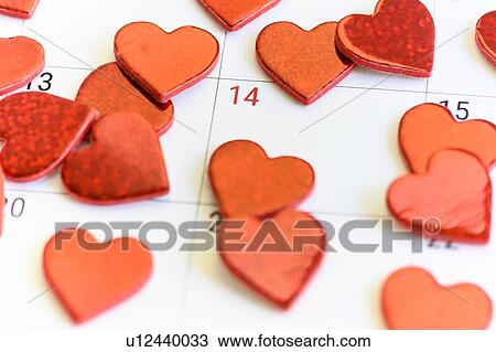 Stock Image - Red hearts on Valentine's Day box on calendar. Fotosearch