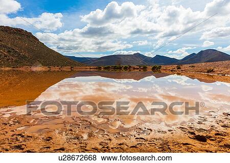 Stock Photo - Reflection of cloudscape in lake, mountain ranges in background, Cape Town, Western Cape, South Africa. Fotosearch