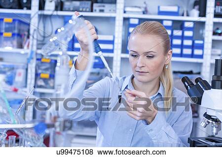 Researcher pipetting sample. View Large Photo Image Stock Photo - Researcher pipetting sample.. Fotosearch
