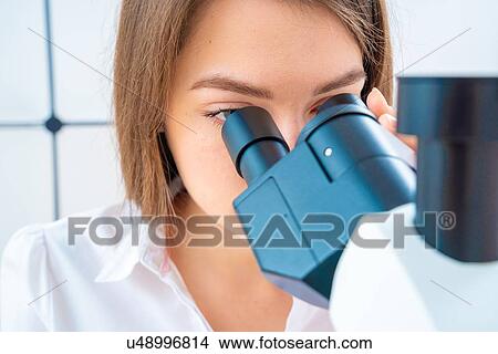 Researcher using microscope. View Large Photo Image Picture - Researcher using microscope.. Fotosearch