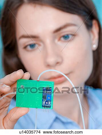 Picture - Researcher with lab on a chip.. Fotosearch