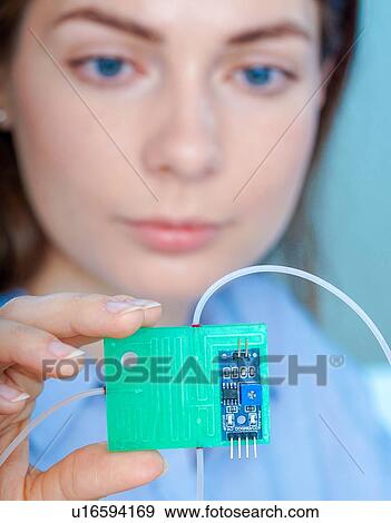 Stock Photo - Researcher with lab on a chip.. Fotosearch