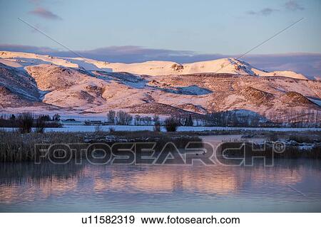 Stock Photo - River and mountains at sunrise in Picabo, Idaho. Fotosearch