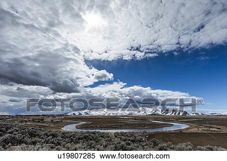 River and mountains under clouds in Picabo, Idaho View Large Photo Image Stock Photography - River and mountains under clouds in Picabo, Idaho. Fotosearch
