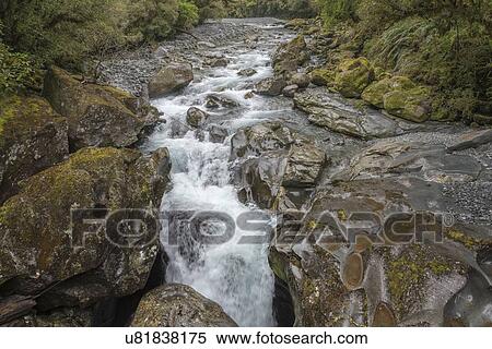 Stock Photography - River over rocks in Milford Sound, New Zealand. Fotosearch