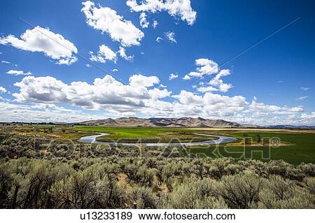 Stock Photo - River through field in Picabo, Idaho, USA. Fotosearch