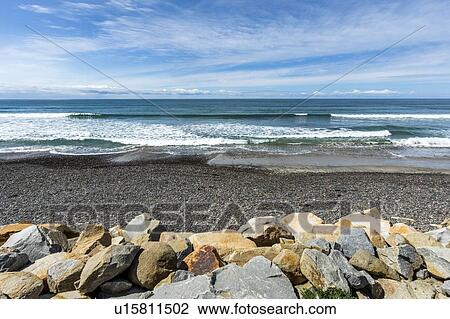 Stock Image - Rocks by beach in San Diego, California. Fotosearch