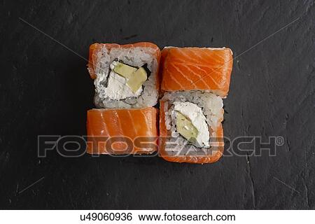 Stock Photograph - Salmon sushi on black surface. Fotosearch