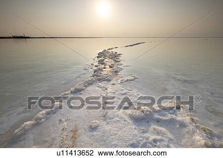 Stock Image - Salt crystallization caused by water evaporation, Dead Sea, Israel.. Fotosearch