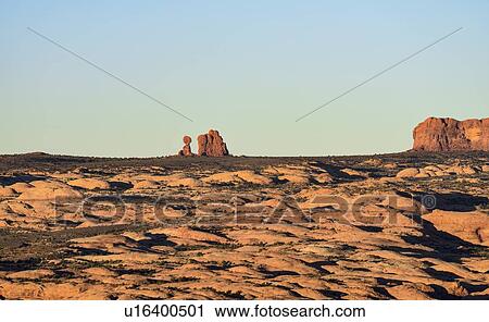 Stock Image - Sand dunes and Balanced Rock in Arches National Park, Utah, USA. Fotosearch