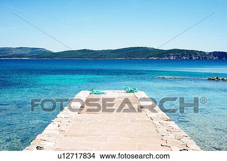 Scenic view of pier and blue sea, Alghero, Sardinia, Italy View Large Photo Image Picture - Scenic view of pier and blue sea, Alghero, Sardinia, Italy. Fotosearch
