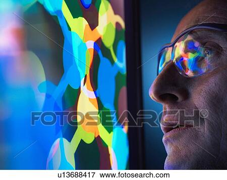 Stock Photo - Scientist understanding the design of a molecular structure on computer screen in laboratory. Fotosearch