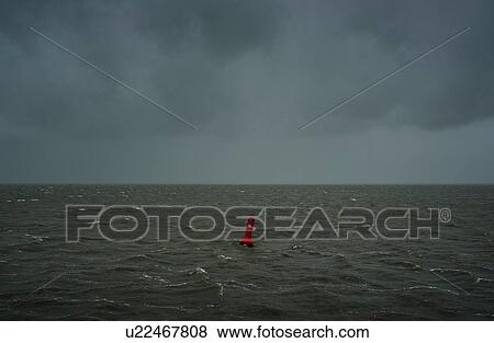 Stock Photo - Seascape with heavy rain and hail over the Waddensea in winter, Hollum, Friesland, Netherlands. Fotosearch
