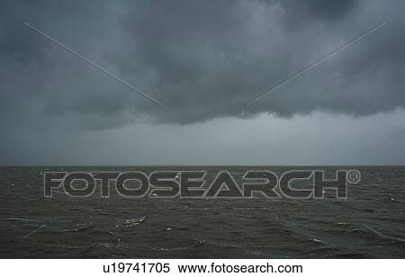 Stock Photography - Seascape with heavy rain and hail over the Waddensea in winter, Hollum, Friesland, Netherlands. Fotosearch