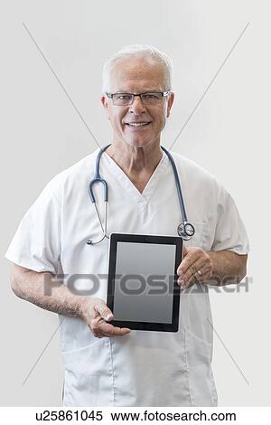 Senior male doctor holding digital tablet, portrait. View Large Photo Image Stock Photography - Senior male doctor holding digital tablet, portrait.. Fotosearch