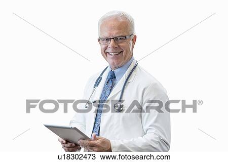 Stock Image - Senior male doctor with digital tablet, studio shot.. Fotosearch