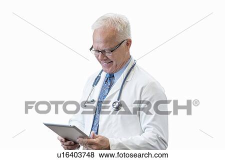 Stock Photo - Senior male doctor with digital tablet, studio shot.. Fotosearch
