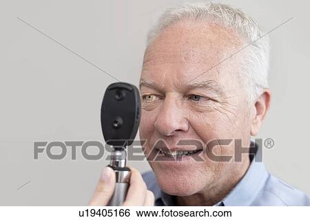 Senior man having eye test. View Large Photo Image Stock Photograph - Senior man having eye test.. Fotosearch