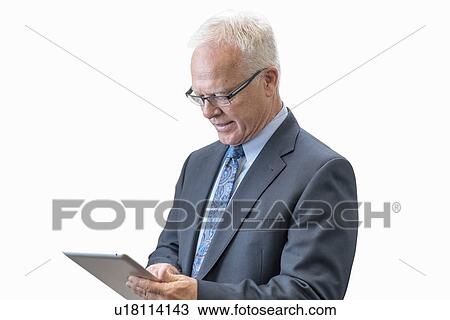 Stock Image - Senior man using digital tablet.. Fotosearch