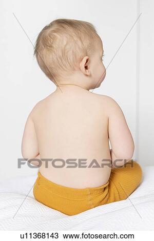 Shirtless girl sitting on bed View Large Photo Image Stock Image - Shirtless girl sitting on bed. Fotosearch