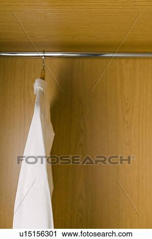 Shirts on clothes hangers in wardrobe View Large Photo Image Stock Image - Shirts on clothes hangers in wardrobe. Fotosearch