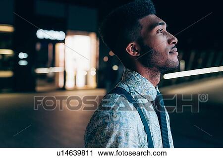 Stock Image - Side view of young businessman. Fotosearch
