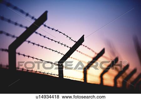Stock Photo - Silhouette of barbed wire fence.. Fotosearch