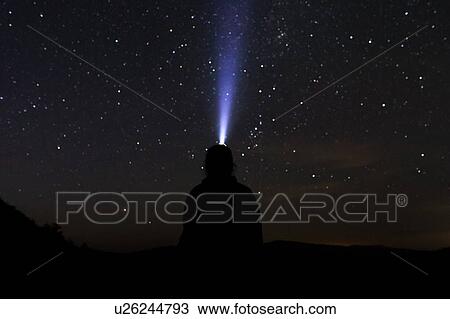 Silhouette of man with headlamp at night View Large Photo Image Stock Image - Silhouette of man with headlamp at night. Fotosearch