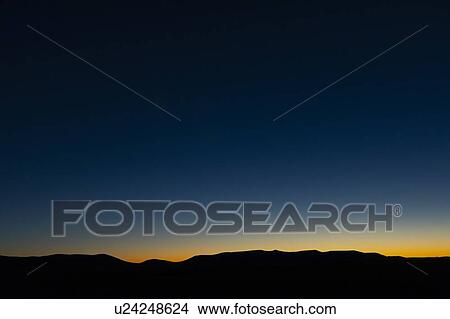 Silhouette of mountains at sunset View Large Photo Image Picture - Silhouette of mountains at sunset. Fotosearch